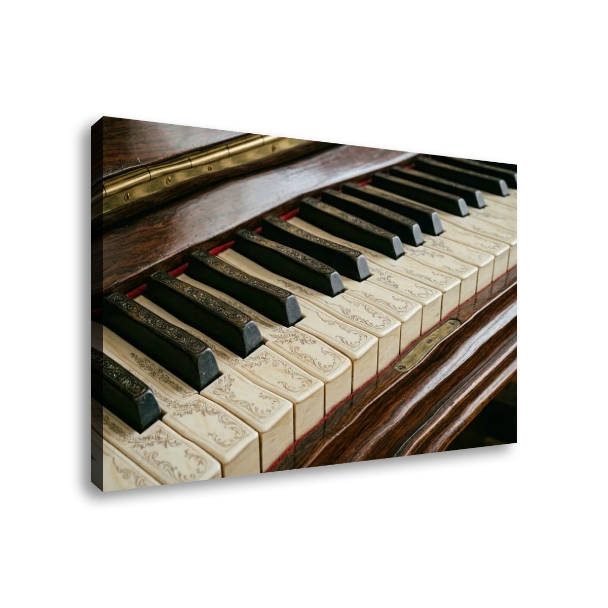 A rectangular wall art print or canvas showing a close-up photograph of piano keys and a dark wooden instrument, displayed at an angle against a plain white background.