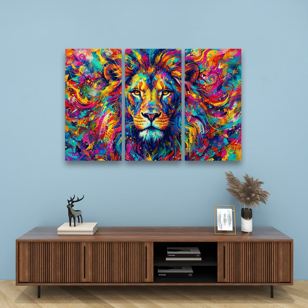 A three-panel canvas wall art set depicting a colorful, vibrant painted lion head, displayed on a light blue wall above a wooden console table with decorative items.