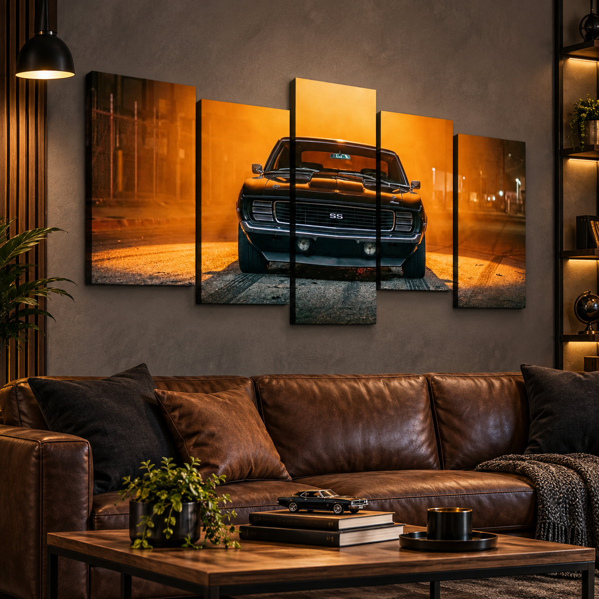 A 5-panel canvas wall art set depicting a black 1969 RS/SS Chevy Camaro muscle car on an orange-lit street at night, displayed on a gray wall above a brown leather sofa in a modern living room setting.