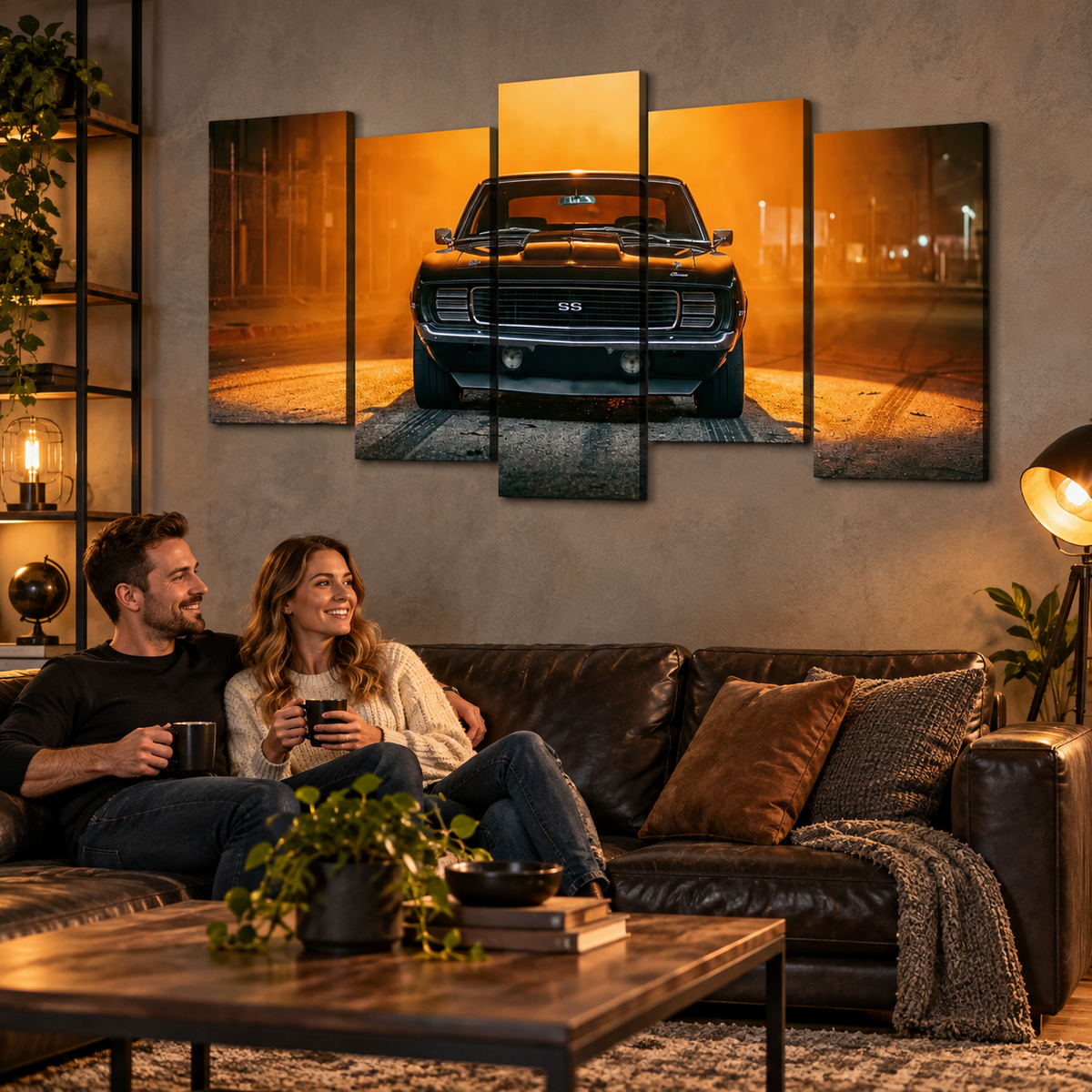 A five-panel canvas wall art set depicting a black 1969 RS/SS Chevy Camaro muscle car on a glowing orange street at night, displayed above a couple sitting on a dark leather couch in a cozy, warmly lit living room.
