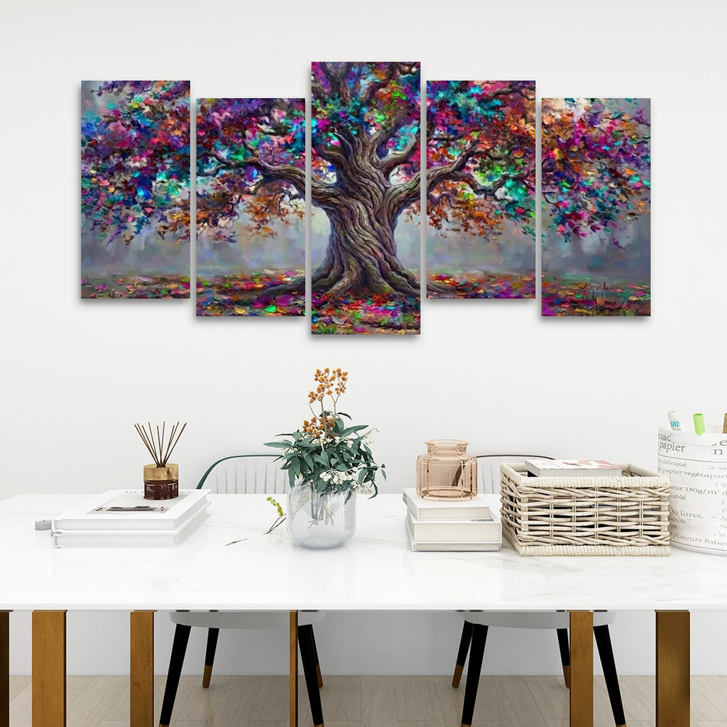 A five-panel canvas wall art set depicting a colorful, vibrant tree with a detailed brown trunk and multicolored foliage, displayed on a white wall above a styled white table with books and a vase.