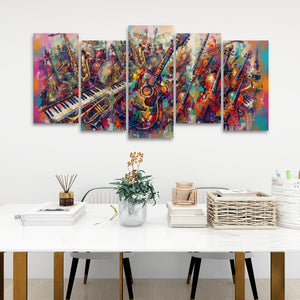 A five-panel canvas wall art set depicting a colorful, abstract painting of musical instruments including guitars, a piano, and brass instruments, displayed on a white wall above a styled white table.