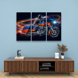 A three-panel canvas wall art set depicting a blue and orange Road Glide type motorcycle with glowing light trails, displayed above a wooden console table in a modern room setting.