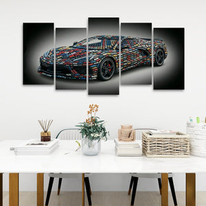 A five-panel canvas wall art set depicting a sports car made from colorful LEGO bricks, displayed on a white wall above a styled dining table with books, a vase, and baskets.