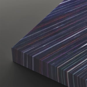 A close-up of a rectangular panel with a dark iridescent surface showing diagonal multicolor stripes in purple, blue, pink, and green, set against a dark gray background.