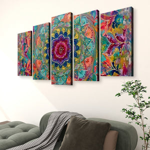 A five-panel canvas wall art set featuring a vibrant, colorful mandala and floral pattern, displayed on a white wall above a green sofa in a living room setting.
