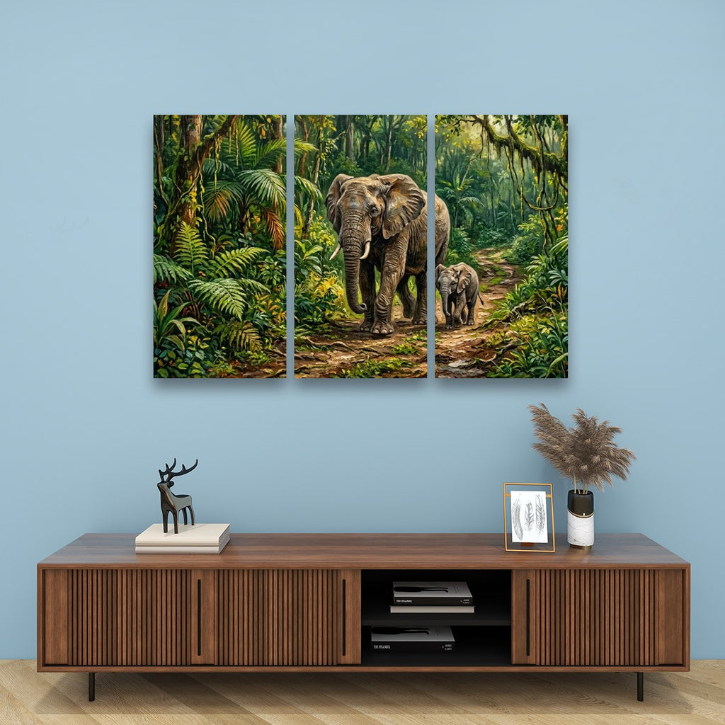 A three-panel canvas wall art set depicting a mother elephant and calf walking through a lush green jungle, displayed on a light blue wall above a wooden console table with decorative items.