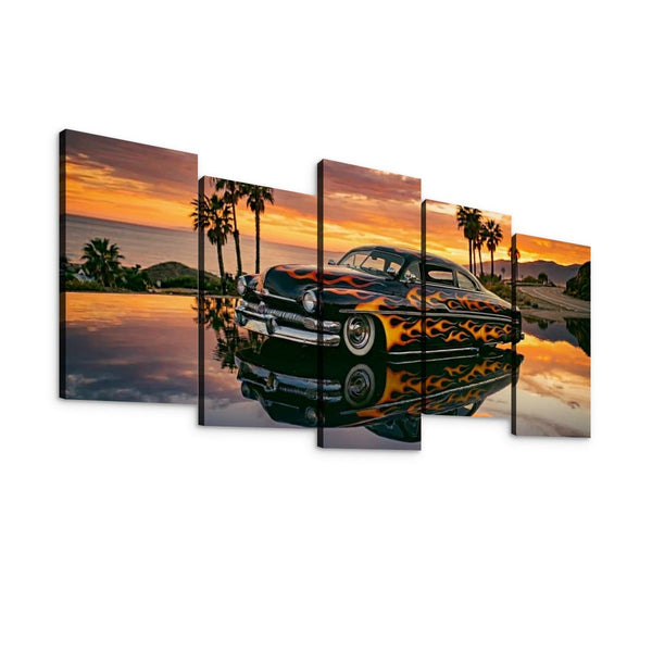 A 5-panel canvas wall art set depicting a classic black car with orange and yellow flame decals, parked by a reflective pool at sunset with palm trees and mountains in the background.