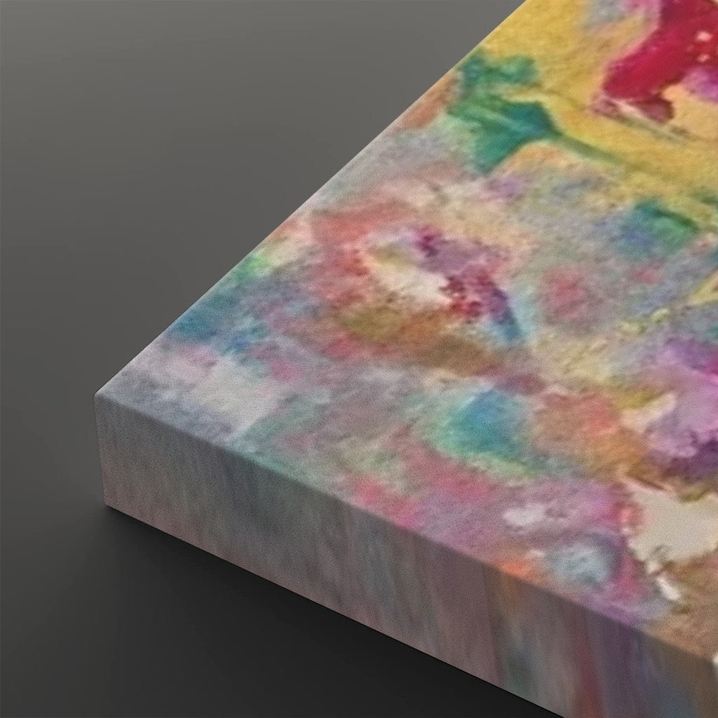 A close-up angled view of a rectangular canvas print showing an abstract watercolor-style design with blended pastel and bright colors including pink, yellow, blue, green, and purple on a dark gray background.