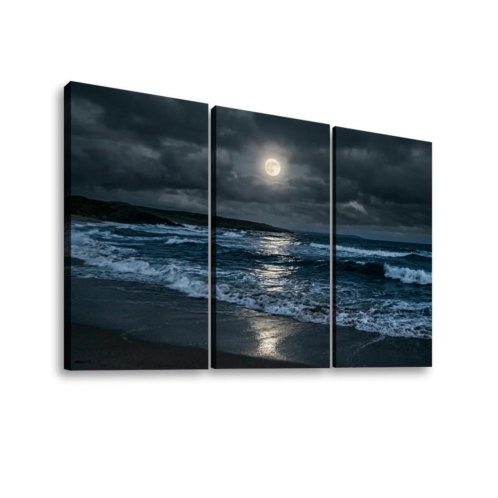 Three-panel canvas wall art showing a moody nighttime beach scene with dark storm clouds, ocean waves, and a bright full moon reflected on the water, displayed against a light gray background.