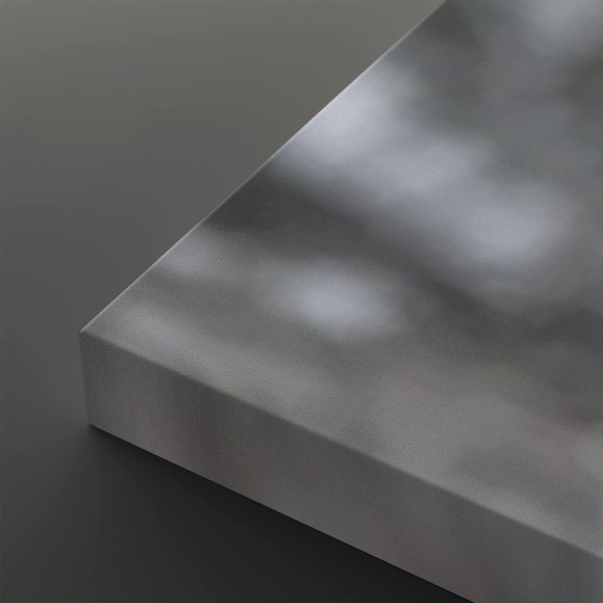A close-up of a matte gray rectangular panel or slab with a softly reflective surface, shown against a dark gray background.