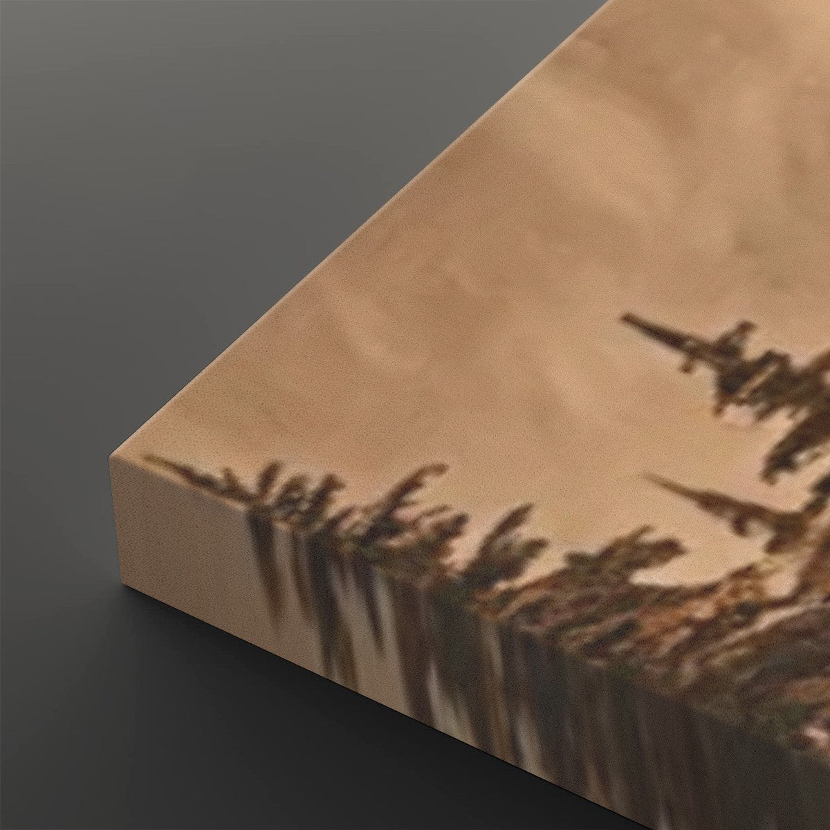A close-up of a rectangular canvas or block featuring a stylized landscape artwork in warm beige and brown tones, with dark tree-like silhouettes and a bright reflective edge, shown on a dark gray background.