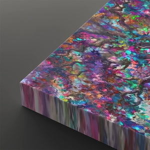 A square canvas print featuring an abstract, colorful tree-bark and foliage pattern with vibrant shades of purple, blue, pink, green, and orange, shown at an angle on a dark gray background.