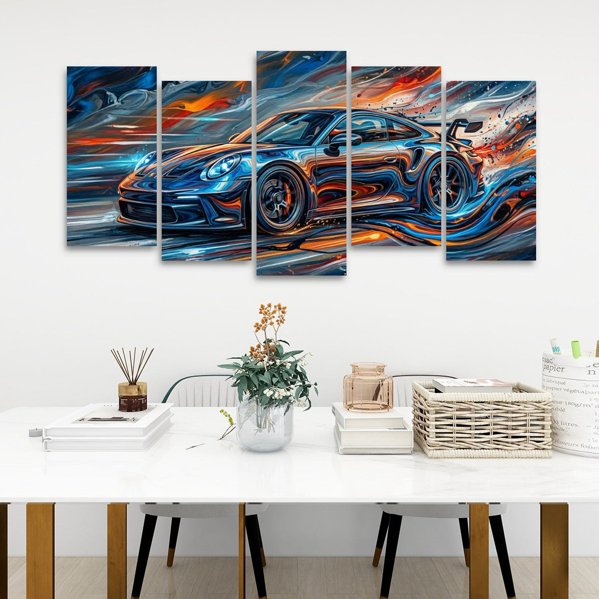 A five-panel canvas wall art set depicting a stylized blue sports car with vivid orange, red, and white brushstroke effects, displayed above a white dining table in a modern room setting.