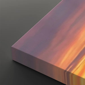 A close-up of a rectangular panel or block with a smooth iridescent surface showing pink, purple, orange, and yellow tones, set against a dark gray background.