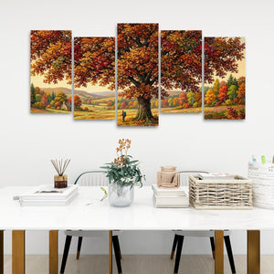 A five-panel canvas wall art set depicting a large autumn tree with red, orange, and yellow foliage over a scenic landscape, displayed on a white wall above a styled white table with books, a basket, and a vase.