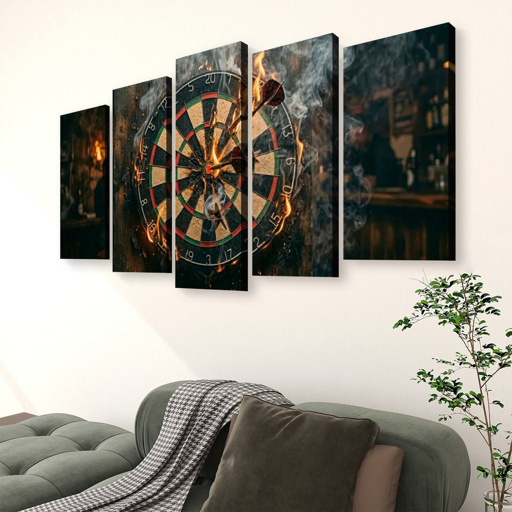 A 5-panel canvas wall art set depicting a dramatic dartboard scene with glowing darts and smoke, displayed above a gray sofa in a modern living room setting.