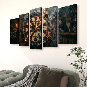 A 5-panel canvas wall art set depicting a dramatic dartboard scene with glowing darts and smoke, displayed above a gray sofa in a modern living room setting.