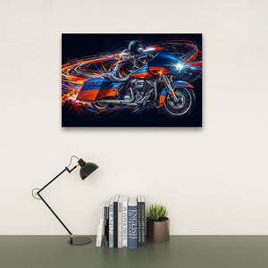 A rectangular wall art print showing a stylized Road Glide type motorcycle with glowing orange and blue light trails, displayed above a desk with a black lamp, books, and a small potted succulent against a light beige wall.