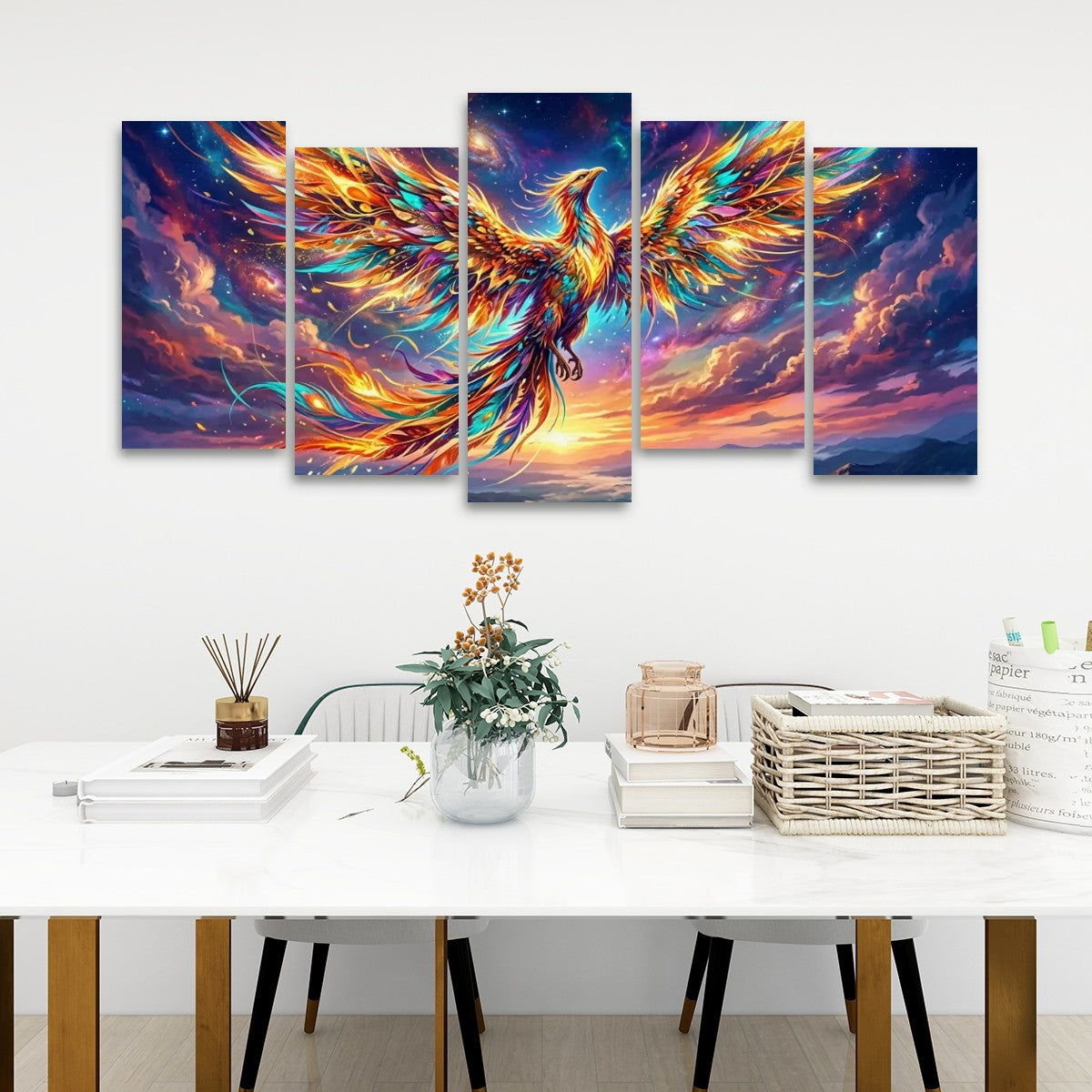 A five-panel canvas wall art set depicting a glowing phoenix with fiery orange, yellow, and blue feathers against a dramatic purple and pink sky, displayed above a white dining table in a modern room setting.