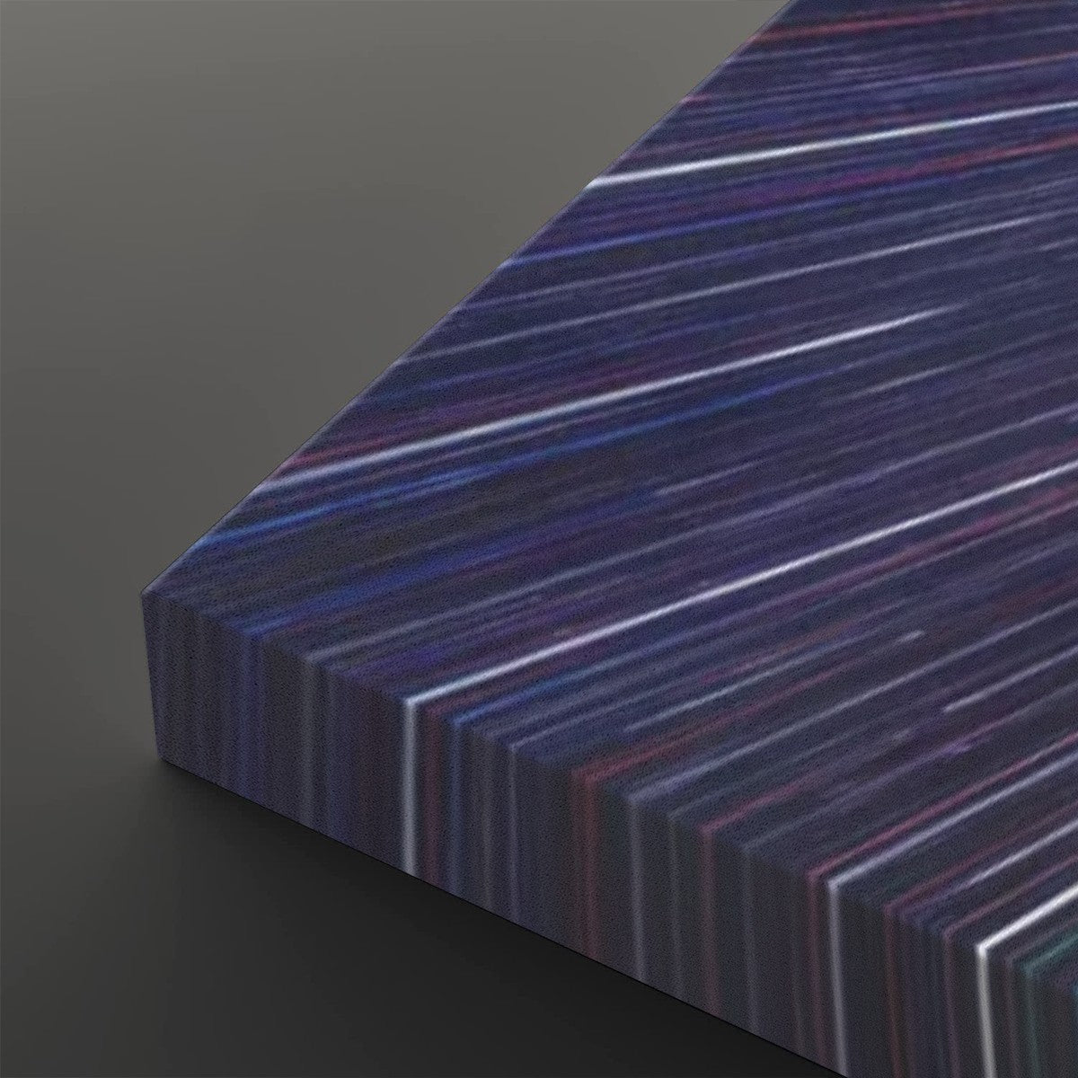 A close-up of a rectangular panel with a dark abstract striped pattern in navy, purple, blue, and white, shown at an angle on a dark gray background.