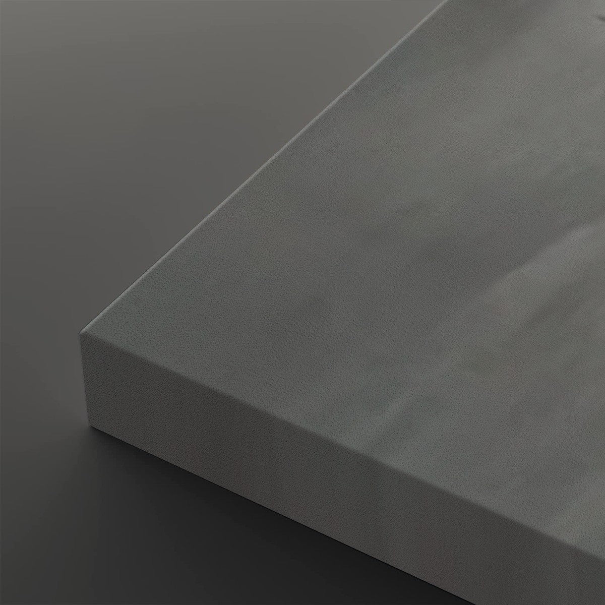 A close-up of a matte gray rectangular panel or tile corner, shown against a matching dark gray background.
