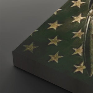 A close-up of a rectangular product, likely a box or package, showing a dark green surface with a pattern of gold stars, photographed on a dark gray background.