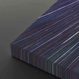 A close-up of a rectangular panel with a dark iridescent striped pattern, showing diagonal bands of purple, blue, pink, and green on a dark gray background.