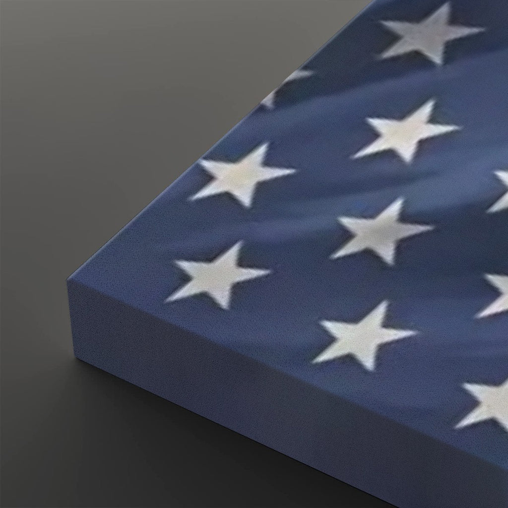 A close-up of a rectangular canvas or panel featuring a blue field with white stars, shown at an angle on a dark gray background.