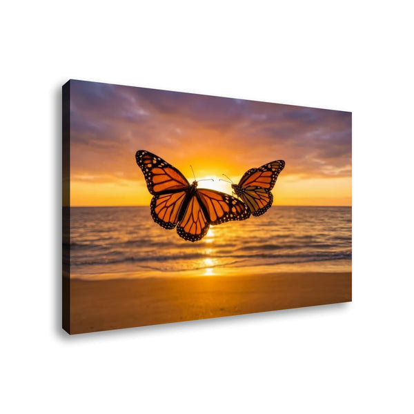 A rectangular wall art canvas showing two orange-and-black monarch butterflies over a beach at sunset, photographed against a plain white background.