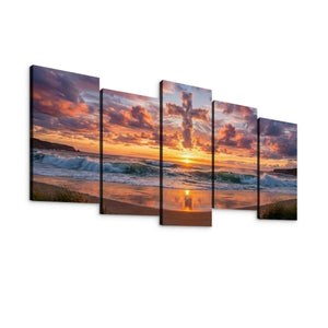 A five-panel canvas wall art set depicting a dramatic beach sunset with orange and pink clouds, waves, and golden light reflecting on the sand, shown against a plain white background.