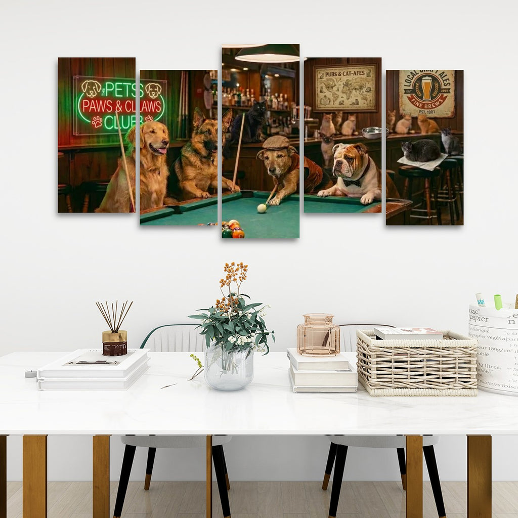 A five-panel canvas wall art set depicting playful dogs playing pool in a bar, displayed on a white wall above a modern white dining table with books, a vase, and baskets.