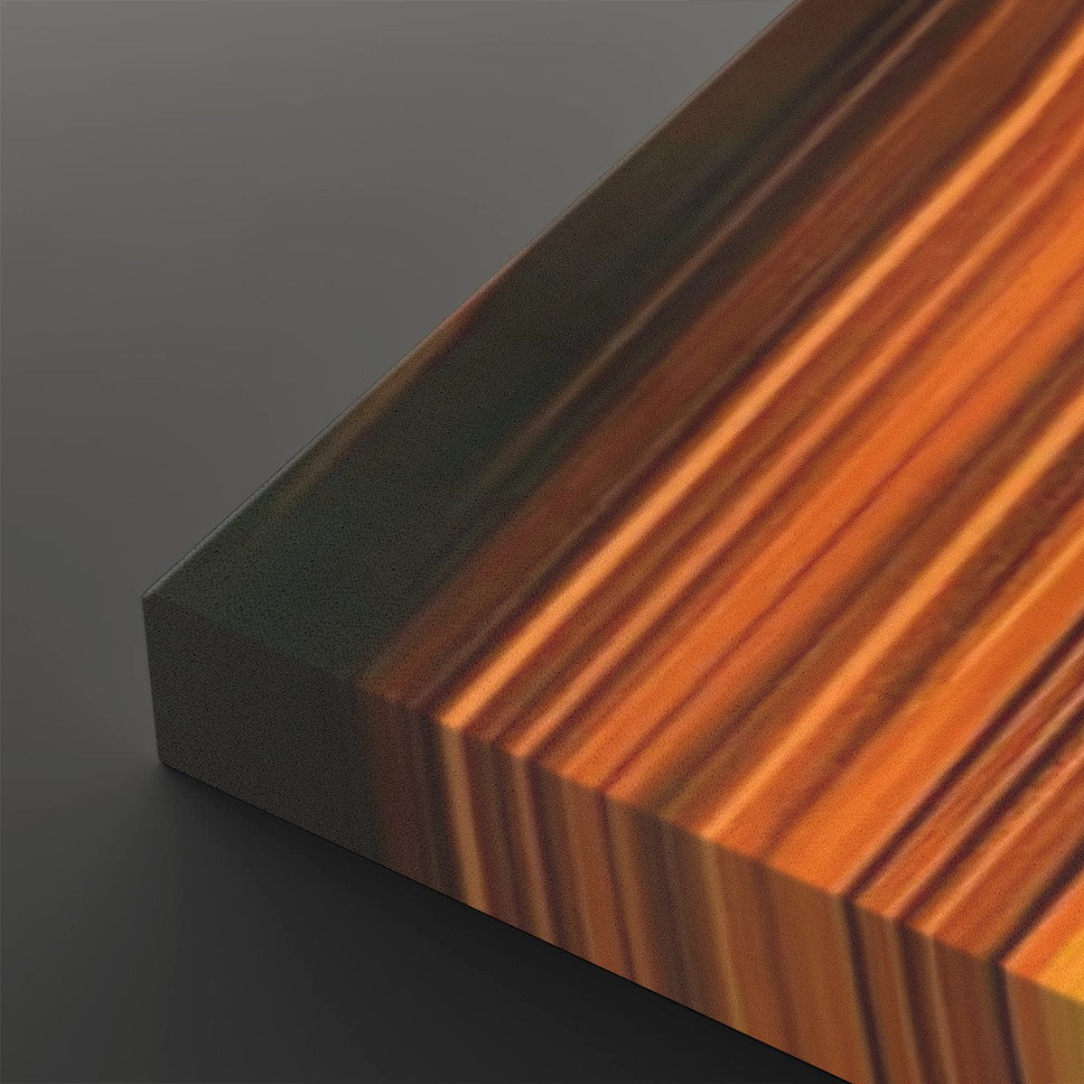 A close-up of a rectangular block with a striped woodgrain pattern in warm orange, brown, and amber tones, shown against a dark gray background.