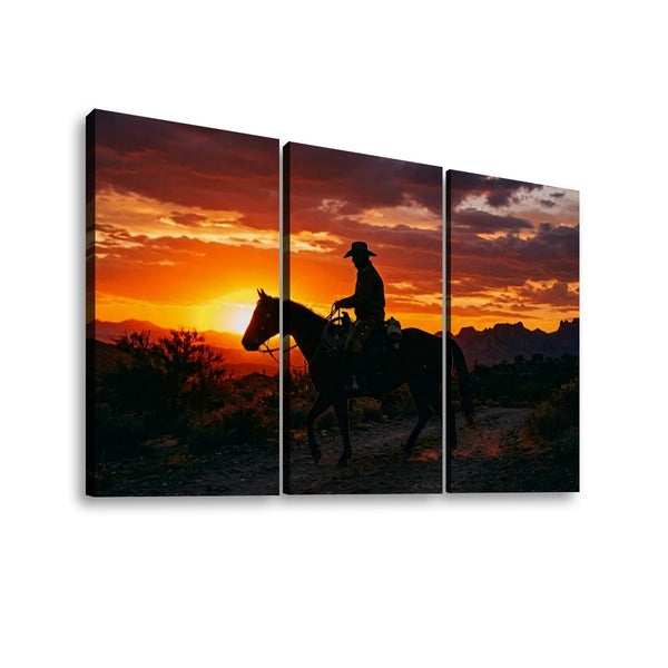 Three-panel canvas wall art showing a silhouetted cowboy riding a horse across a desert landscape at sunset, with a dramatic orange, red, and dark sky.