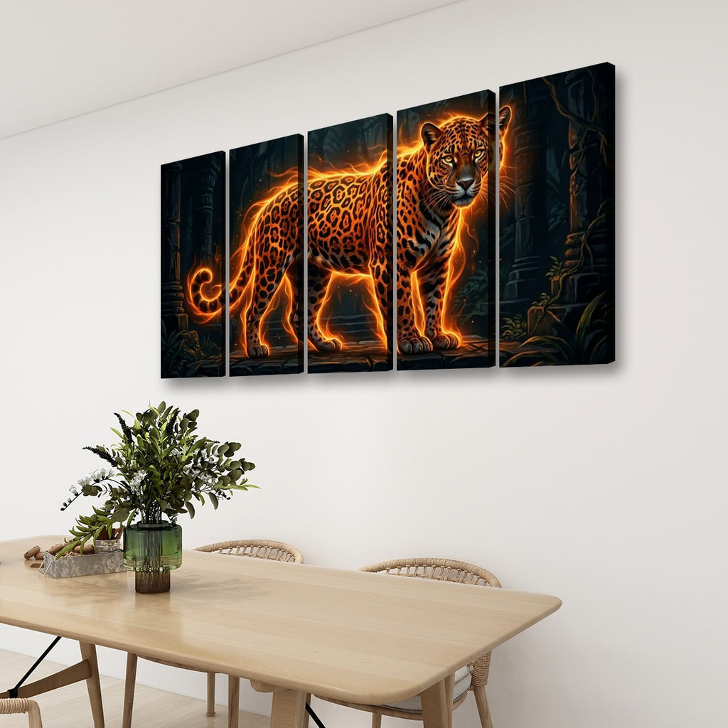A four-panel canvas wall art set depicting a glowing orange leopard against a dark jungle background, displayed on a white wall above a wooden dining table with chairs and a plant.