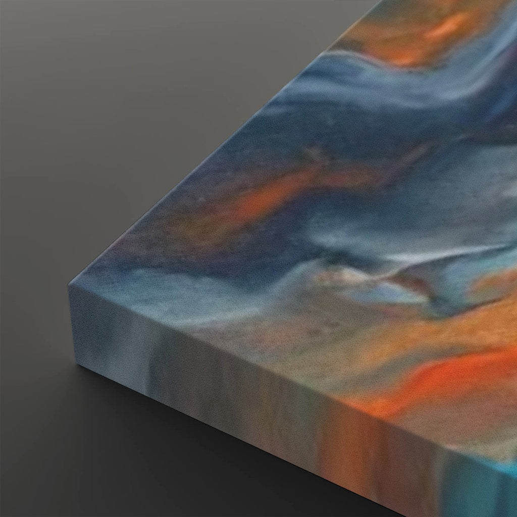 Abstract canvas wall art showing a marbled fluid design with swirling shades of blue, gray, white, and orange, photographed at an angle on a dark gray background.