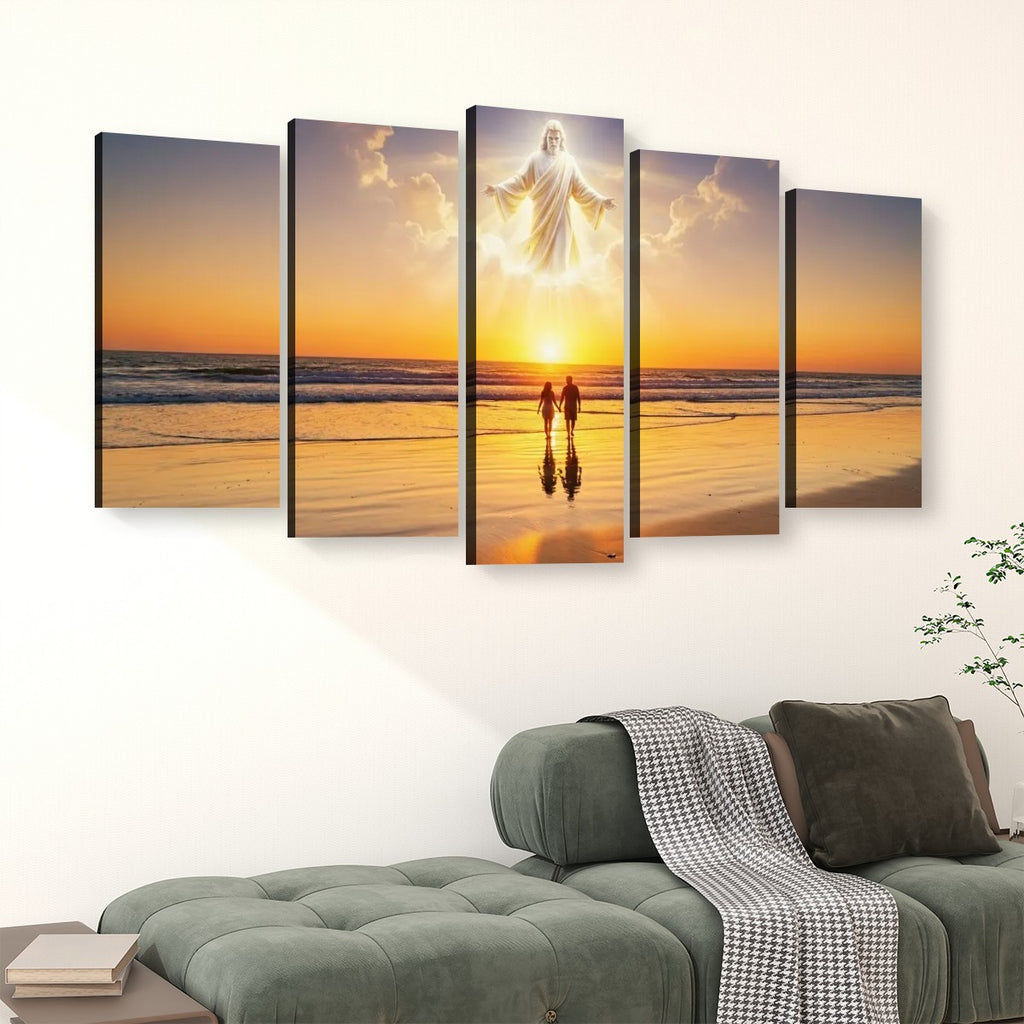 A 5-panel canvas wall art set depicting a beach sunset with a glowing figure above two small figures, displayed above a green sofa in a living room setting.