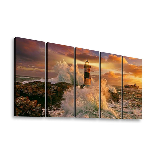 A five-panel canvas wall art set depicting a dramatic lighthouse scene with crashing waves, rocky shore, and a warm sunset sky.