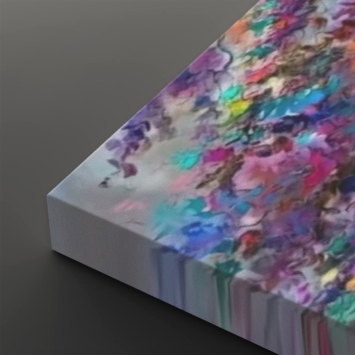 Abstract canvas wall art showing a colorful paint-dripped design on a dark gray background.