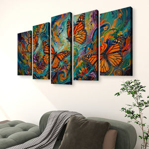 A five-panel canvas wall art set depicting vibrant orange monarch butterflies over colorful swirling abstract backgrounds, displayed on a white wall above a green sofa in a living room setting.