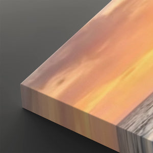 A close-up of a rectangular wooden block or panel with a warm gradient finish shifting from peach and orange to yellow, with a gray wood-grain edge visible on the right side, set against a dark gray background.