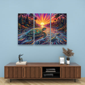 A three-panel canvas wall art set depicting a colorful sunset over a river with a sea turtle, displayed above a wooden console table in a styled room setting.