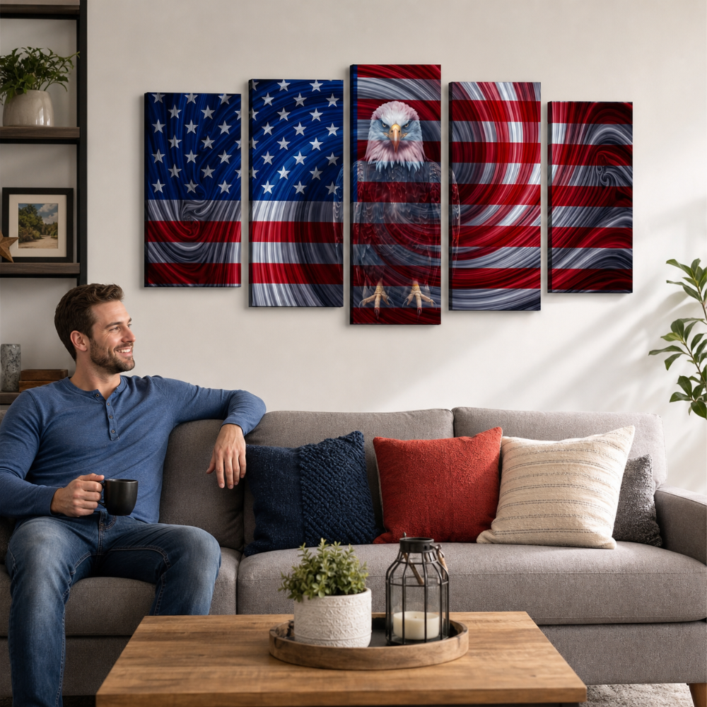 A man sits on a gray sofa holding a mug in a living room, with a five-panel canvas wall art set depicting the American flag and an eagle design hanging above the couch.