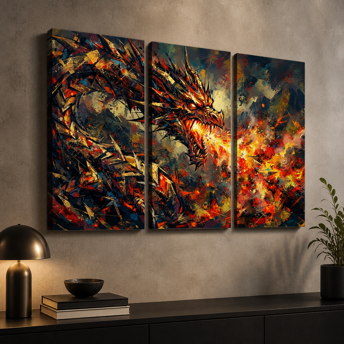 Three-panel canvas wall art showing a dramatic fiery dragon in an abstract, painterly style, displayed above a dark console table with a lamp, books, and a plant in a modern interior setting.
