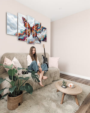 Woman sitting on a couch in a living room with a colorful butterfly artwork on the wall.