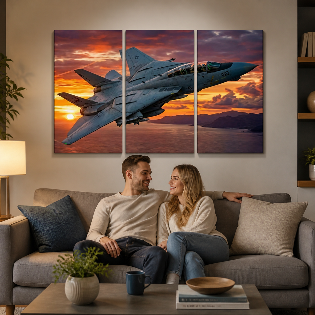 A three-panel canvas wall art set depicting a gray Grumman F-14 military fighter jet flying over a sunset landscape, displayed on a beige wall above a living room sofa with a couple sitting underneath.