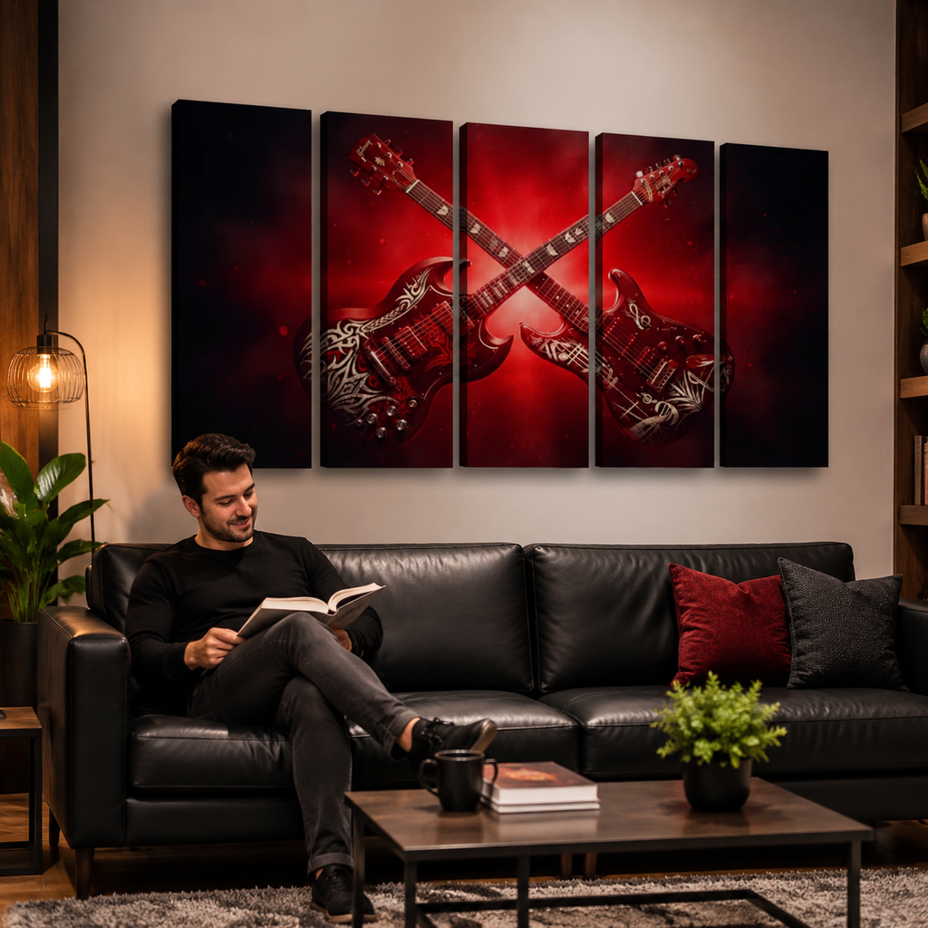 A man sits on a black leather sofa in a living room, reading a book. The wall above the couch features a five-panel canvas wall art set depicting two red electric guitars crossed against a dark red and black background.