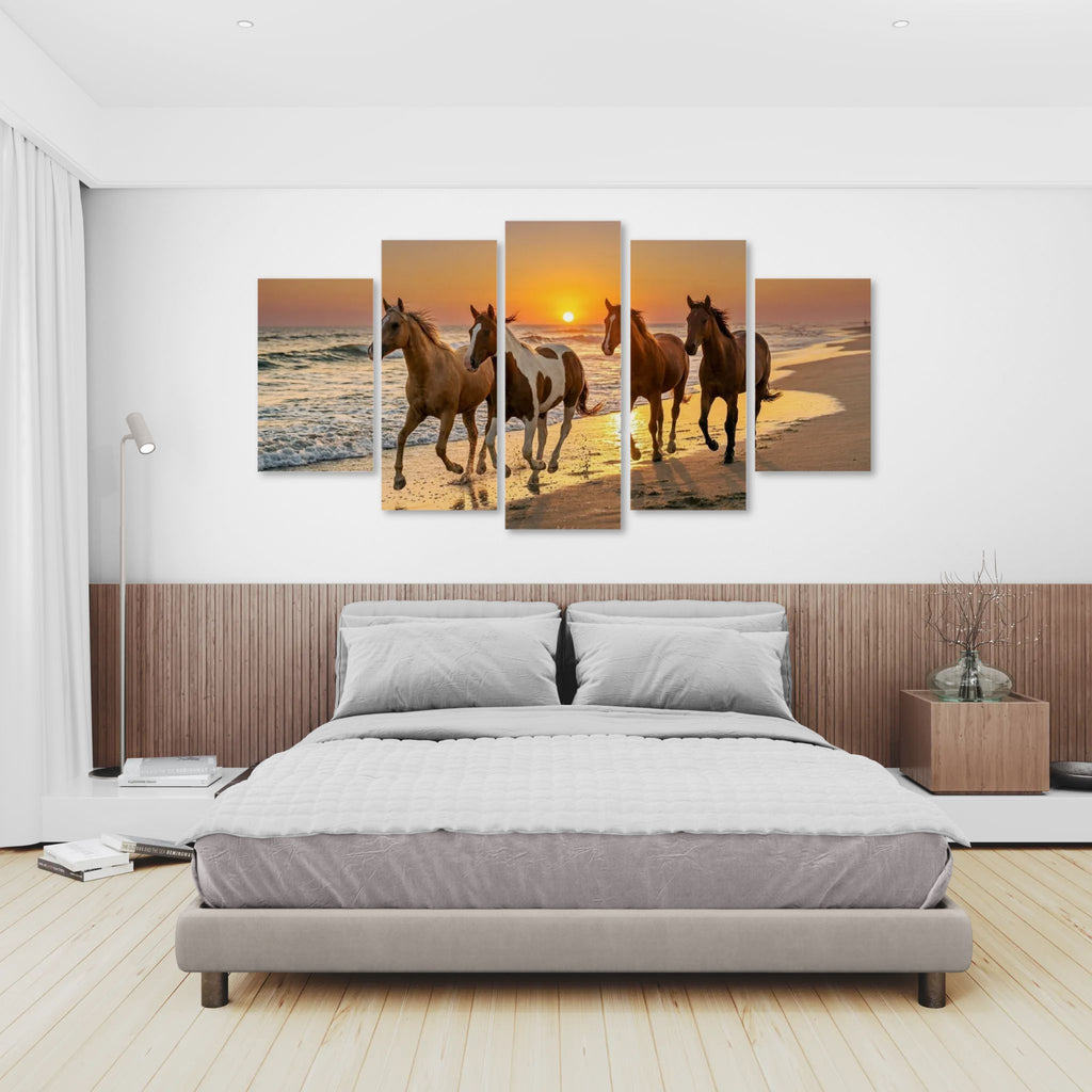 Bedroom with a large wall art of horses on a beach at sunset.