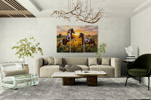 Living room with a beige sofa, coffee table, and wall art of horses at sunset.