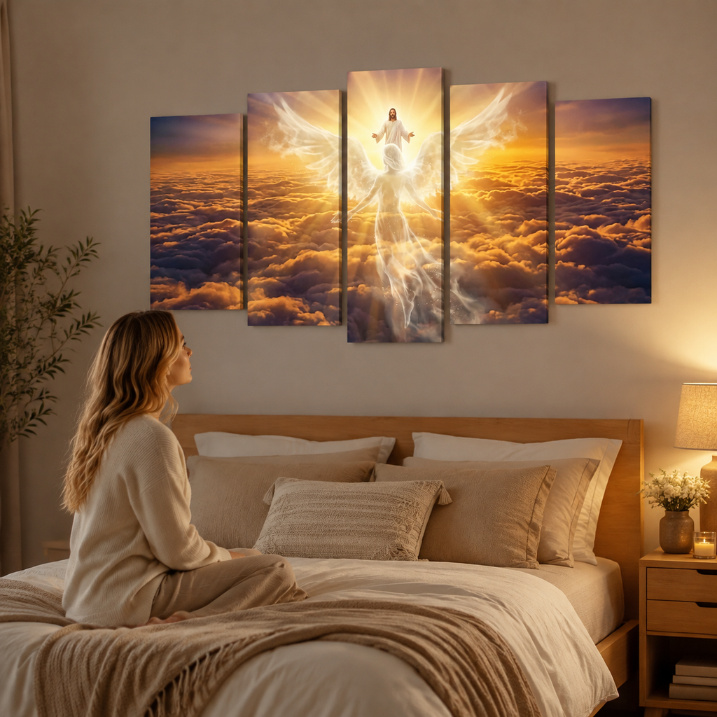 A woman sits on a bed in a warmly lit bedroom, looking at a five-panel canvas wall art set depicting a glowing angel figure above clouds at sunset. The room includes a wooden headboard, beige bedding, a bedside lamp, and a plant.